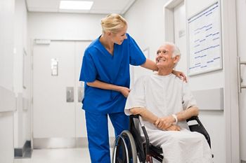 Nurse looking at elderly patient in a wheelchair in hospital ward. Doctor talking to old disabled in hospital hallway.; Shutterstock ID 643149502; purchase_order: DNC Thumbnails; job: Webinars 2 (50/188); client: ; other: 