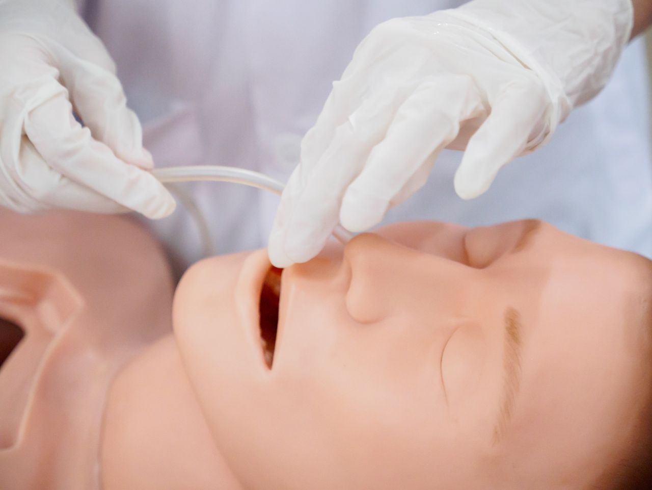 Close-up detail of a physician inserting a nasogastric tube into a training model. Healthcare and education concept.; Shutterstock ID 659625325; purchase_order: DNC Thumbnails; job: Videos; client: ; other: 