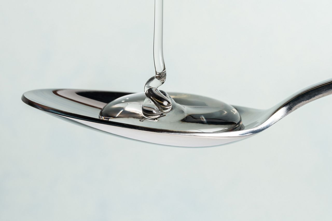 Pouring Light Corn Syrup on a Spoon; Shutterstock ID 671435683; purchase_order: DNC Thumbnails; job: Publications; client: ; other: 