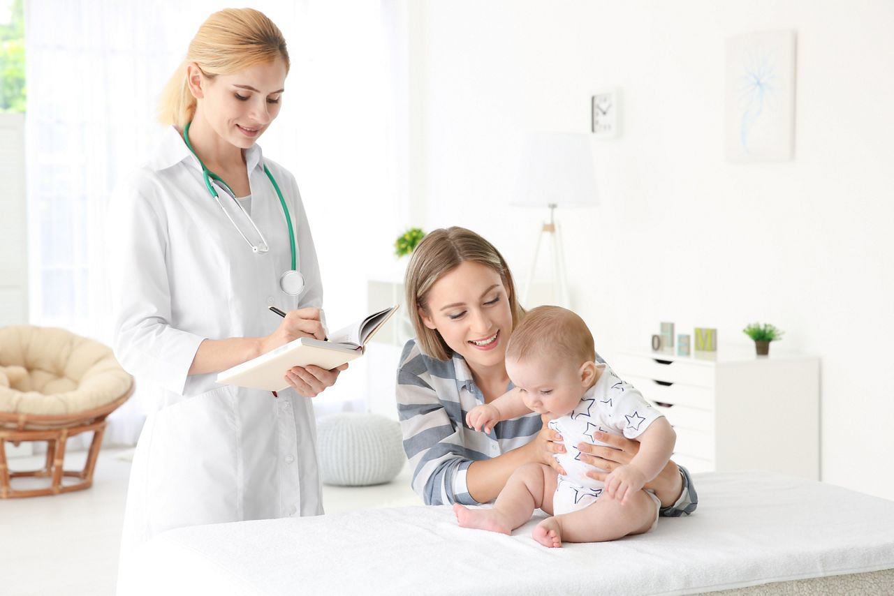 Doctor writing something in notebook and mother with baby at home; Shutterstock ID 707933488; purchase_order: DNC Thumbnails; job: Courses; client: ; other: Replace Fishwife