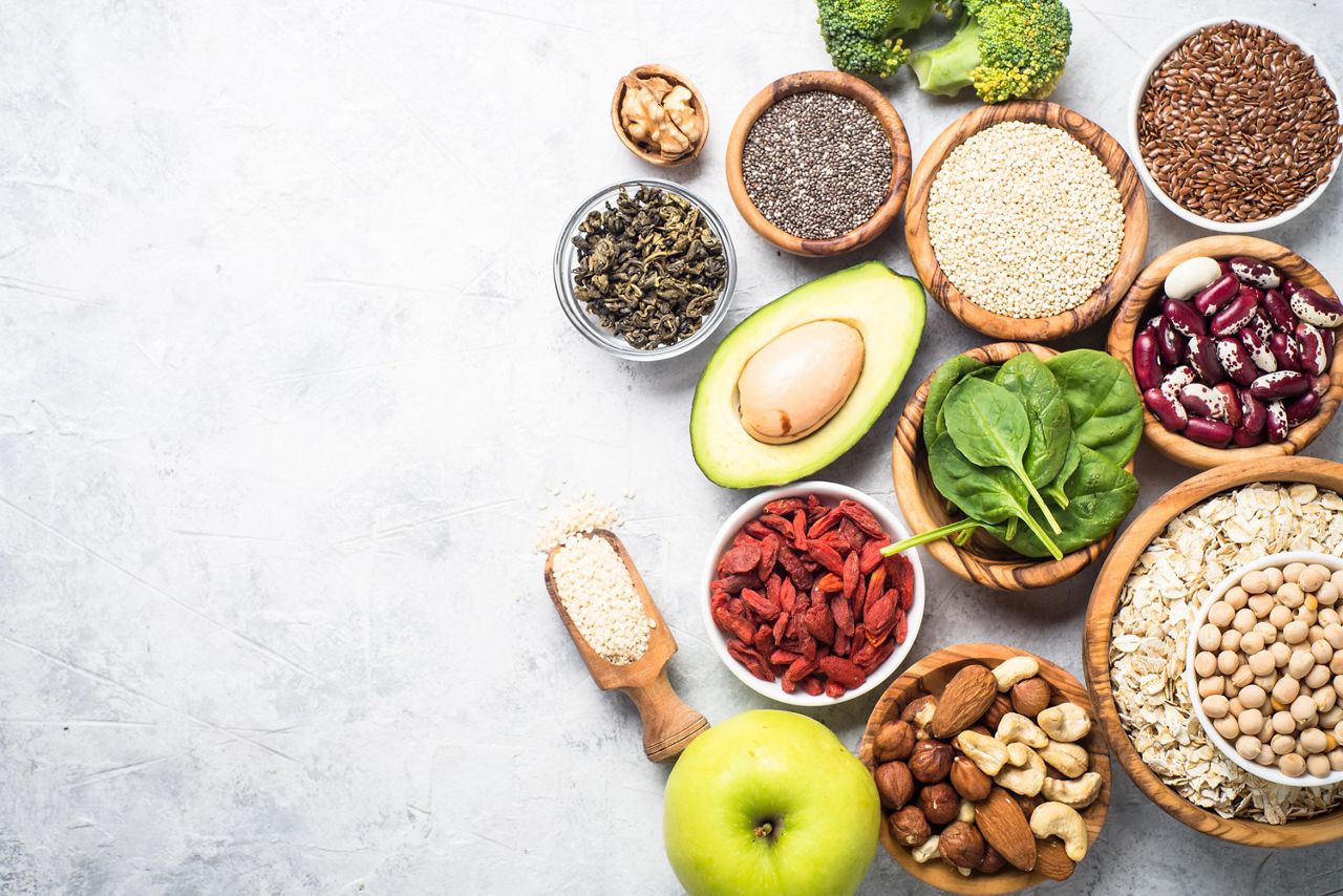 Superfoods on a gray background with copy space. Nuts, beans, greens and seeds. Healthy vegan food.; Shutterstock ID 736087222; purchase_order: DNC Thumbnails; job: Webinars 2 (50/188); client: ; other: 