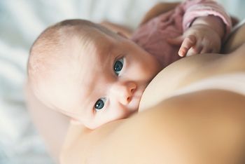 Baby eating mother's milk. Mother breastfeeding baby. Beautiful mom breast feeding her newborn child. Young woman nursing and feeding baby. Concept of lactation infant.; Shutterstock ID 745570315; purchase_order: DNC Thumbnails; job: Webinars 2 (50/188); client: ; other: 