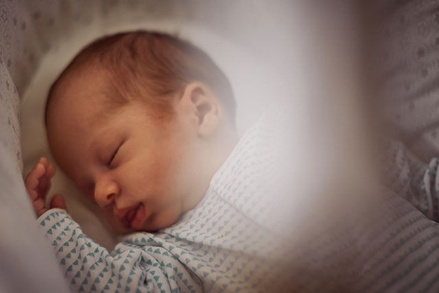 sleeping baby in cot