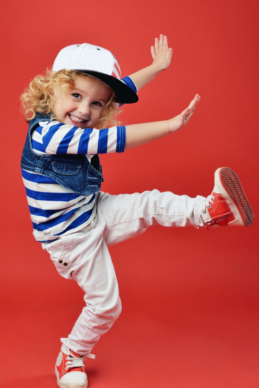 Portrait of a cute little girl in fashionable clothes