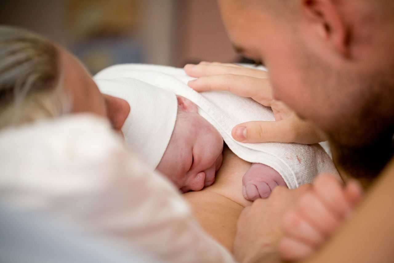 Newborn baby girl right after delivery, shallow focus