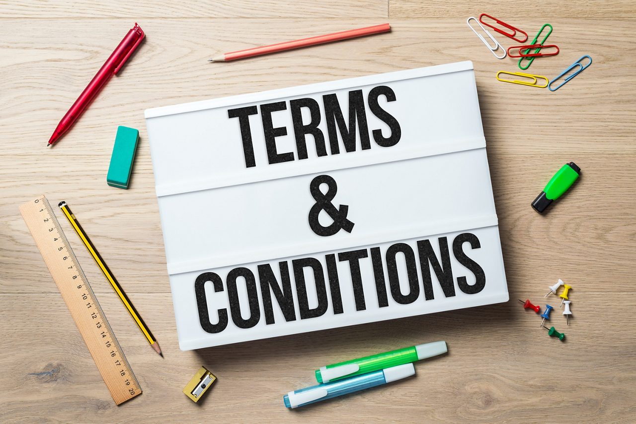 Terms and conditions writing in lightbox with pen, pencil, highlighter and ruler lying on office desk as flat lay getty images 915625402