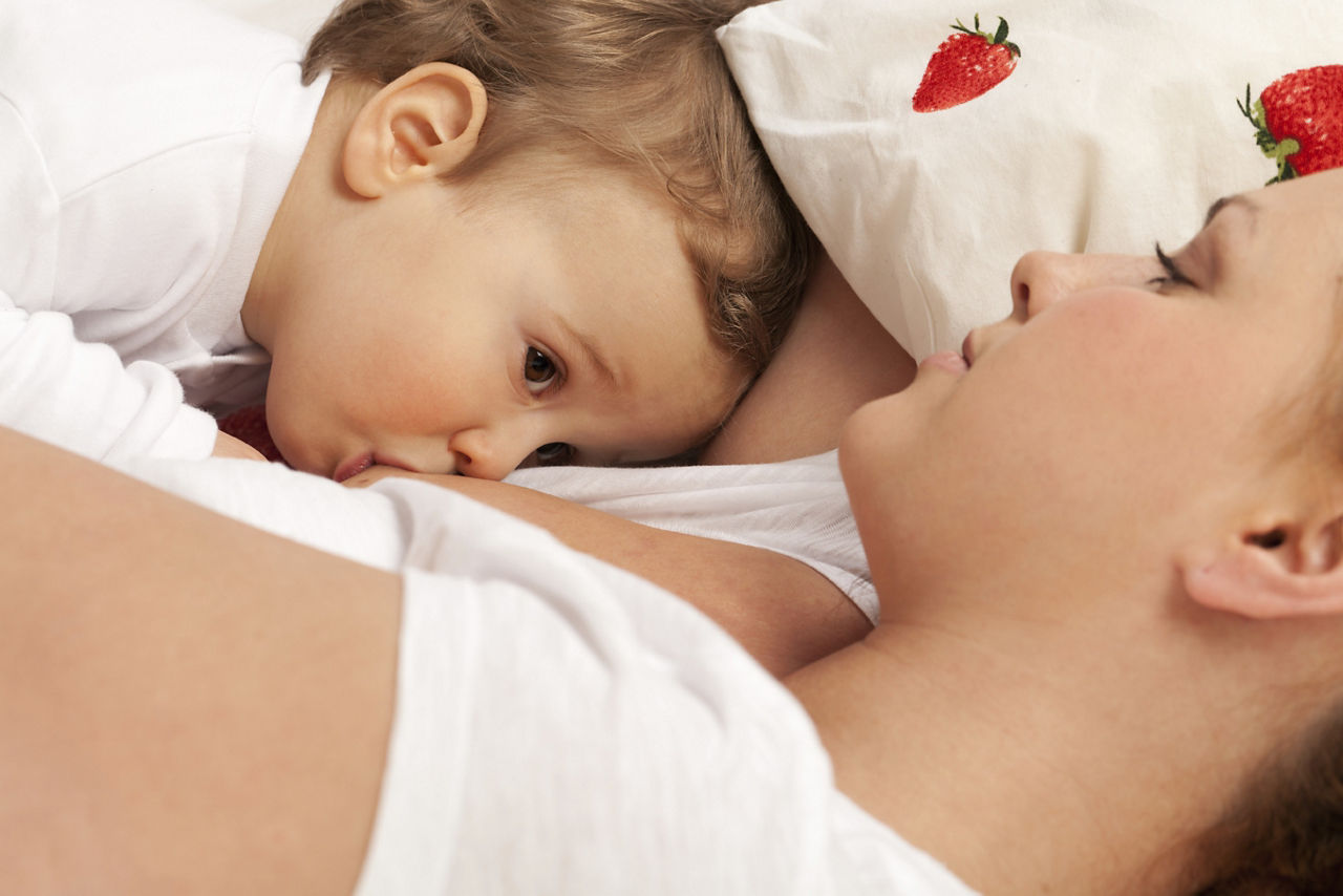 Mother feeds son with breast