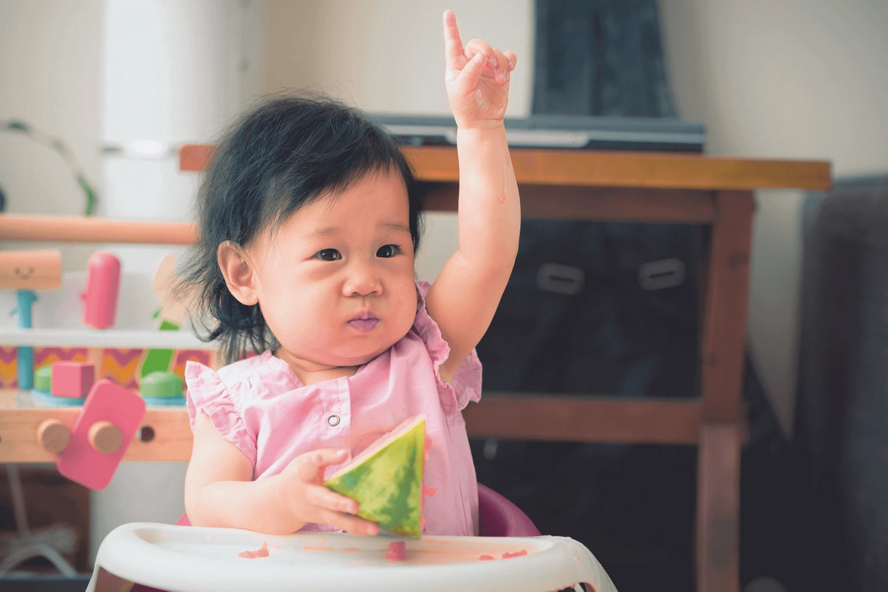   Baby holding watermellon