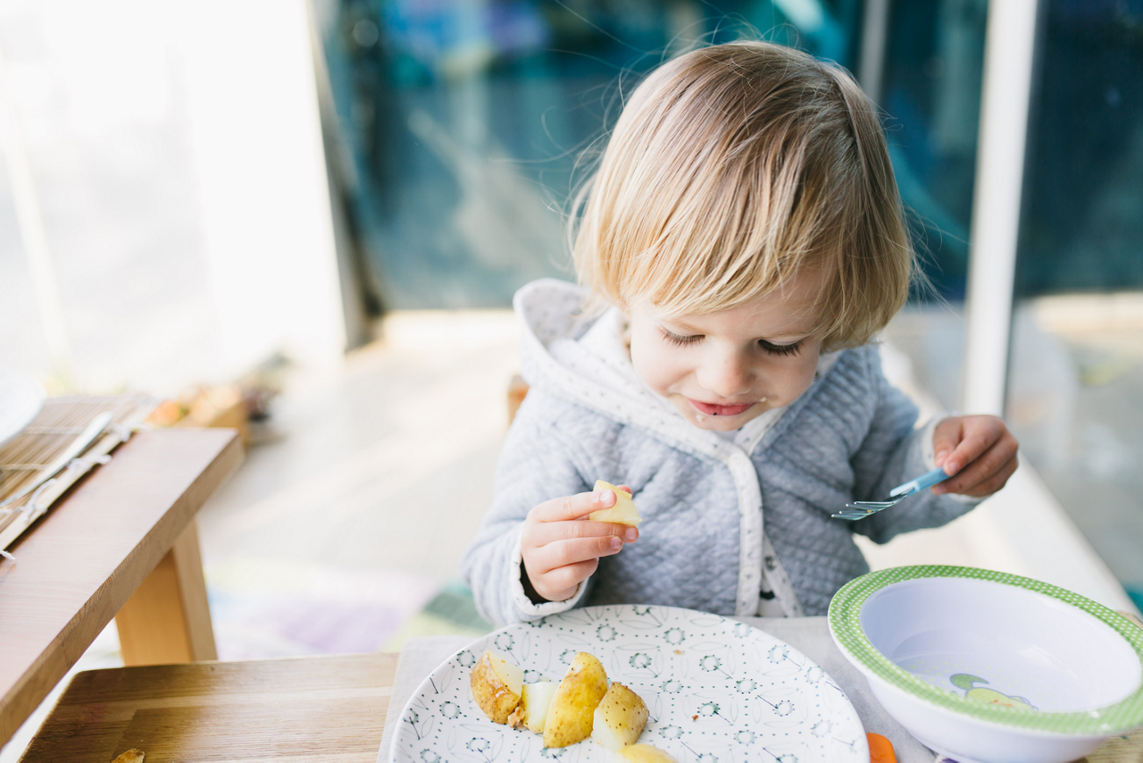 Toddler girl baked potato