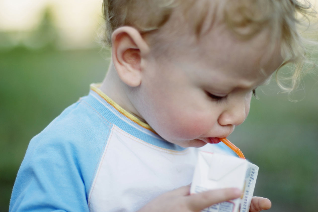 Toddler holding juice