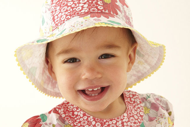 toddler in hat smiling