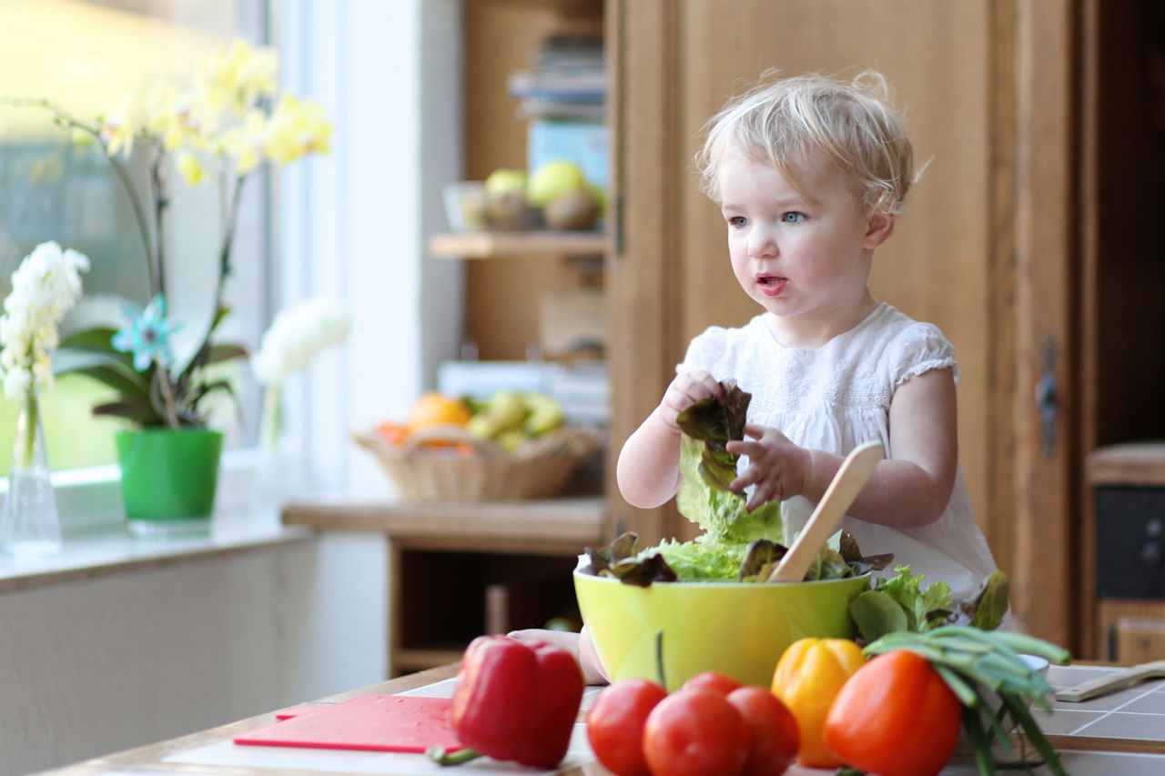Toddler preparing vegetables