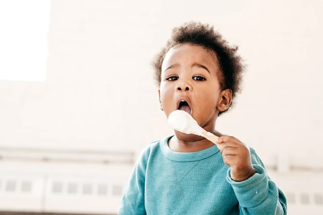 toddler with spon