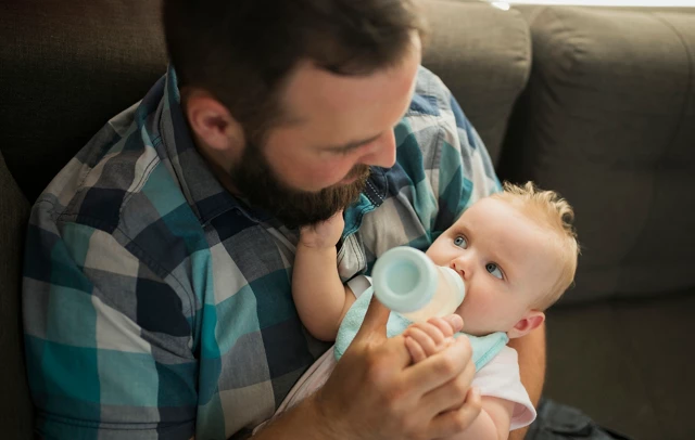 father feeding baby
