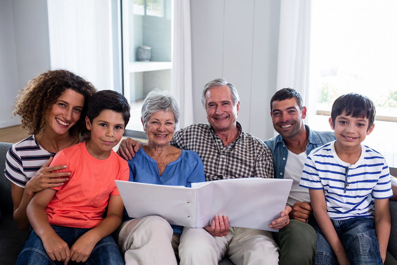 Familiy smiling and sitting on a couch