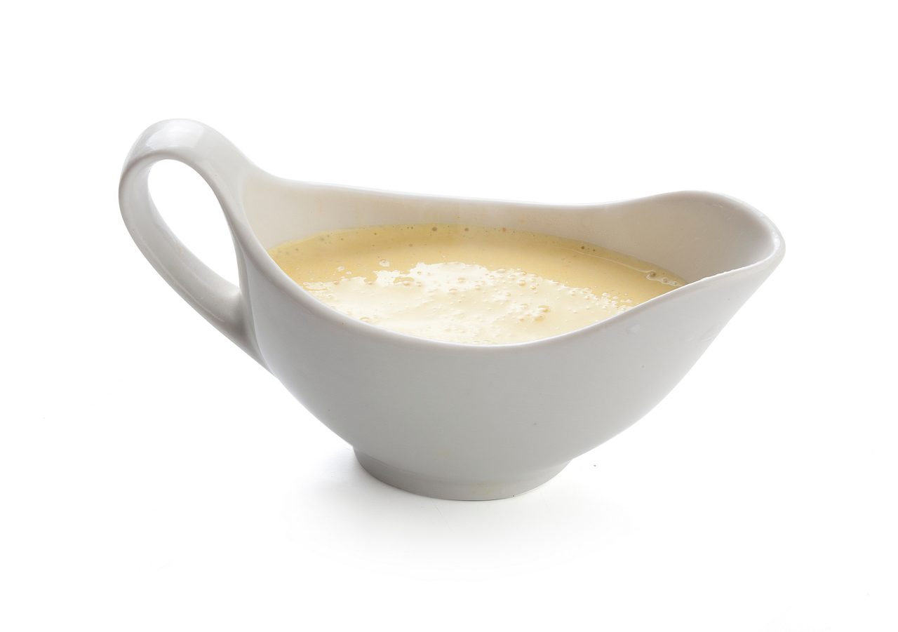 Creamy cheese sauce in the white sauceboat