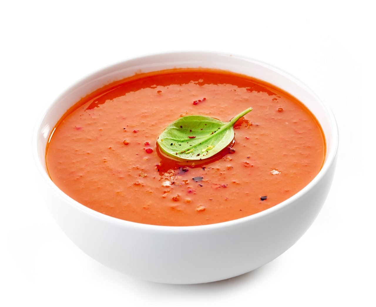 Bowl of tomato soup on a white background