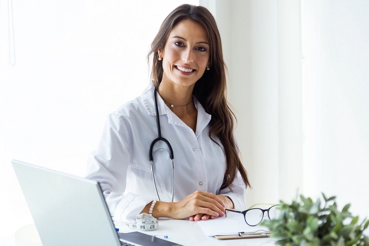 Portrait of beautiful young female doctor looking at camera in the office.