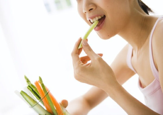 Woman eating veggie sticks