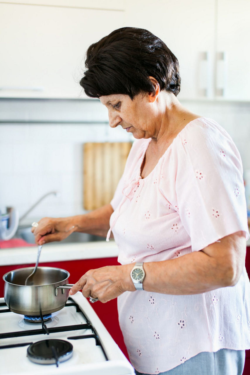 Woman cooking on hob