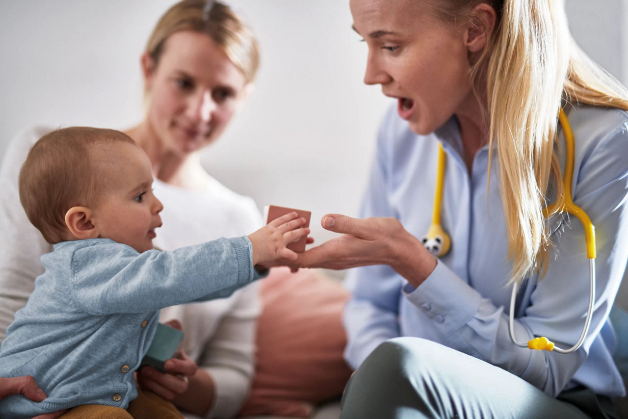 Doctor playing with baby