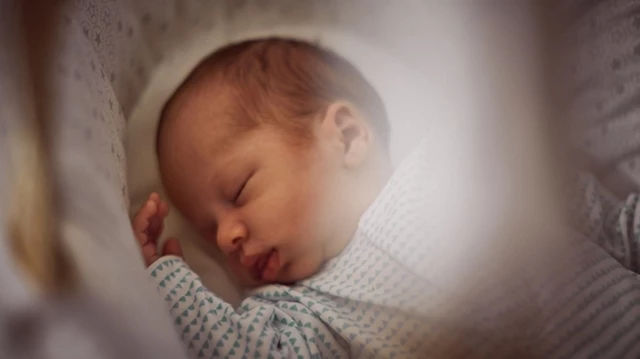 Sleeping baby in cot