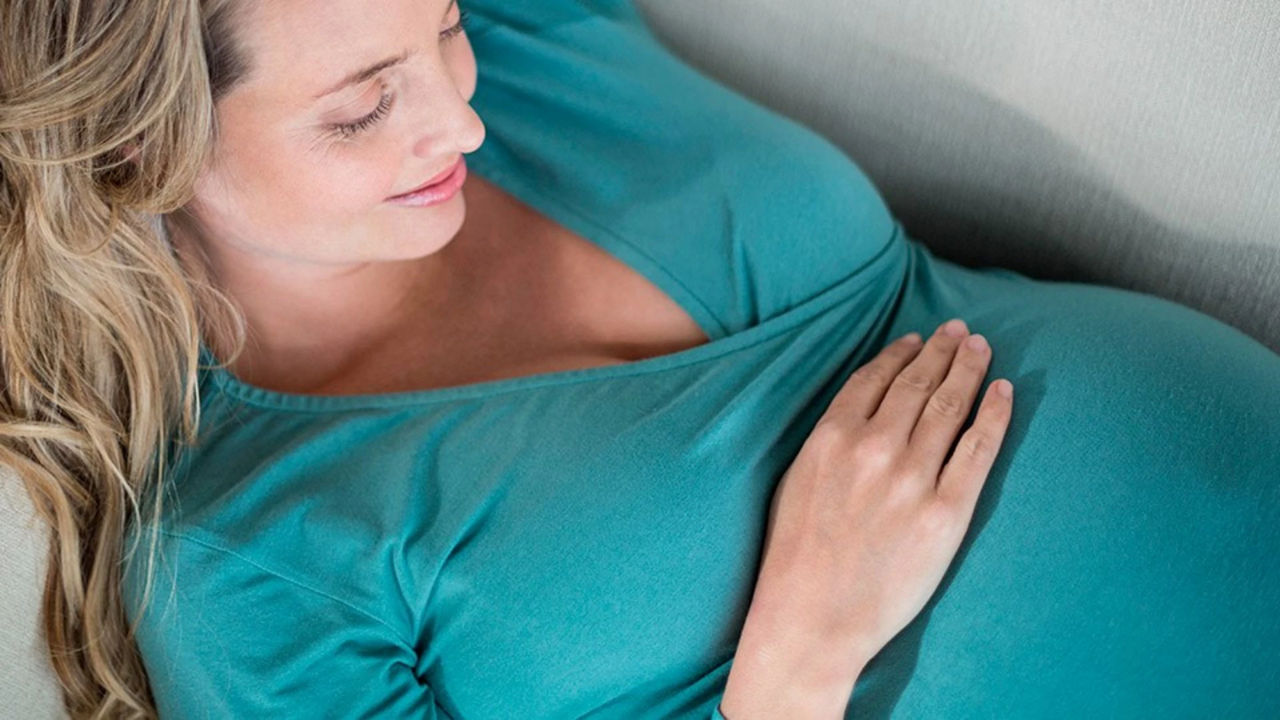 woman-smiling-at-baby-bump