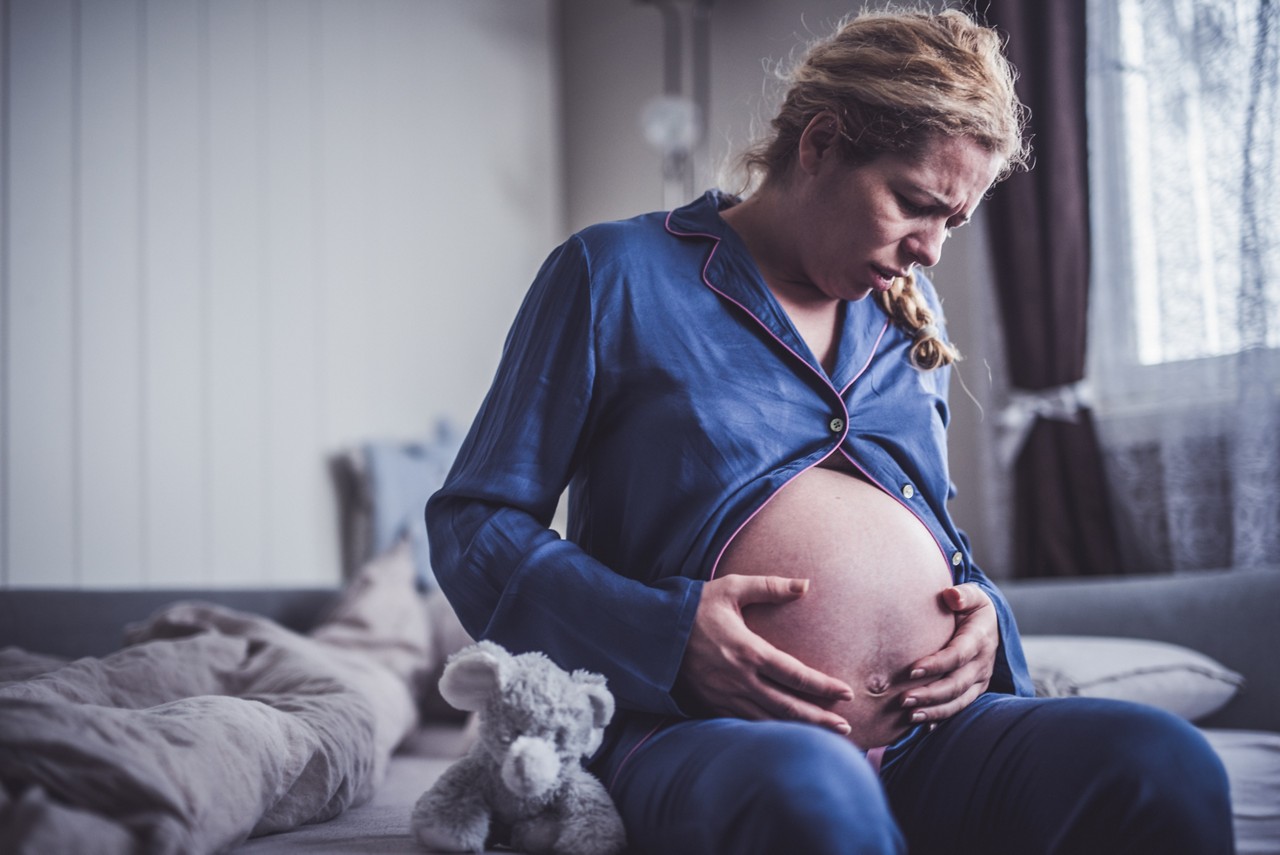 Screaming pregnant woman having pains.